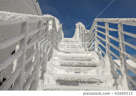 Snow and ice covered stairs and windows Snow and ice covered stairs and windows 43840515