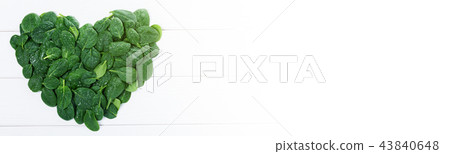 Heartshaped sign made of green spinach leaves 43840648