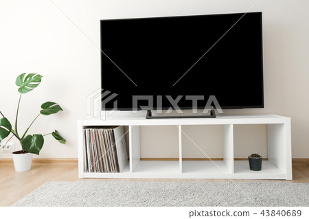 Cozy home interior with TV and monstera palm Cozy home interior with TV and monstera palm 43840689