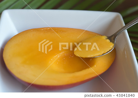 Spoon into a lonesome mango image Spoon into a lonesome mango image 43841840