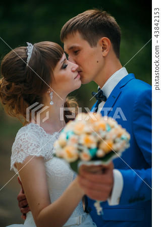 young bride and groom kissing on the background  43842153
