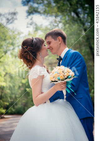young bride and groom embracing against  43842155