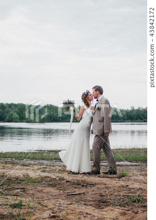 young groom and bride standing hugging young groom and bride standing hugging 43842172