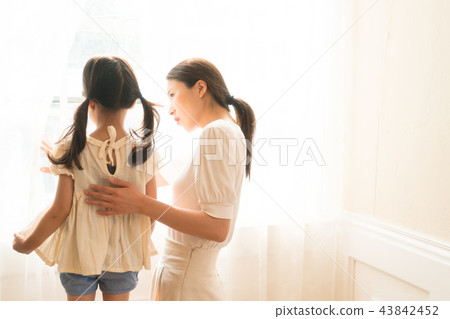 A girl standing on a window A girl standing on a window 43842452