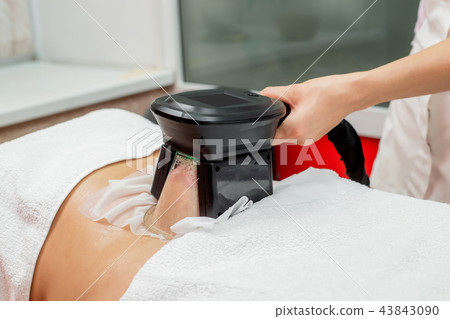 Woman getting cryolipolysis in cosmetic cabinet Woman getting cryolipolysis in cosmetic cabinet 43843090