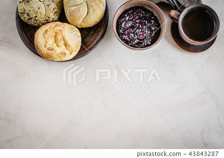 Breakfast: coffee americano, fresh buns and jam. Breakfast: coffee americano, fresh buns and jam. 43843287