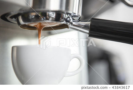 Barista using coffeemaker extraction for espresso 43843617