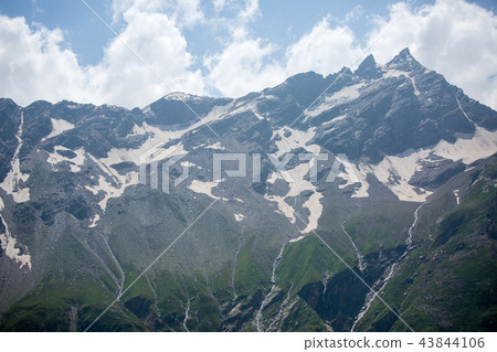 Image of mountain slopes with vegetation, cloudy sky 43844106