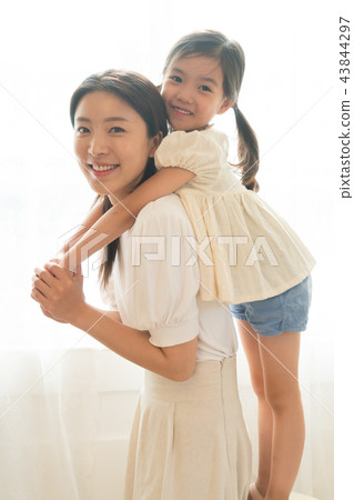 Mother and Child Standing at the Window 43844297