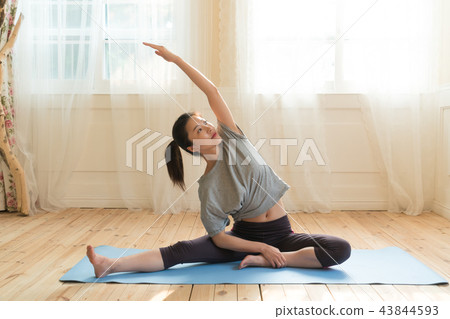 A woman doing yoga A woman doing yoga 43844593