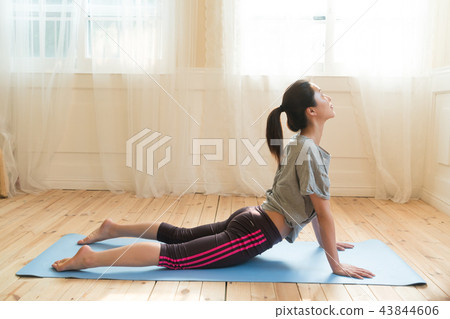 A woman doing yoga A woman doing yoga 43844606