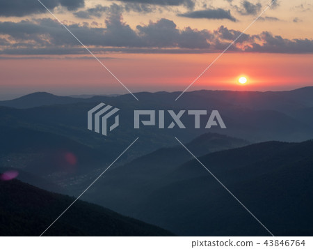 Landscape of red sunset in mountains. The sun 43846764