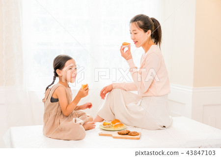 Mother and Child enjoying home baking Mother and Child enjoying home baking 43847103