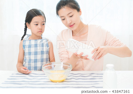 Mother and Child enjoying home baking Mother and Child enjoying home baking 43847161