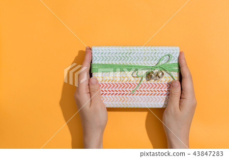 Woman holding a gift box Woman holding a gift box 43847283