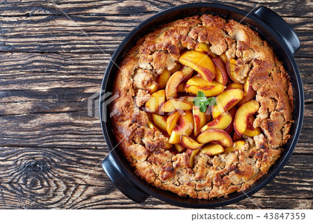 Delicious peach cobbler with a sweet pastry crust 43847359