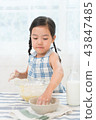 A girl enjoying home baking 43847485