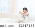 A girl enjoying home baking 43847488