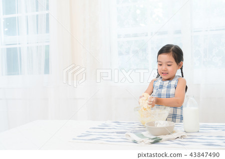 A girl enjoying home baking A girl enjoying home baking 43847490