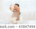 A girl enjoying home baking 43847494