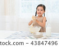 A girl enjoying home baking 43847496