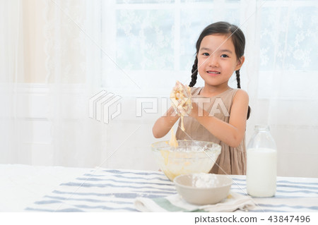 A girl enjoying home baking A girl enjoying home baking 43847496