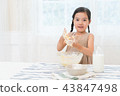 A girl enjoying home baking 43847498