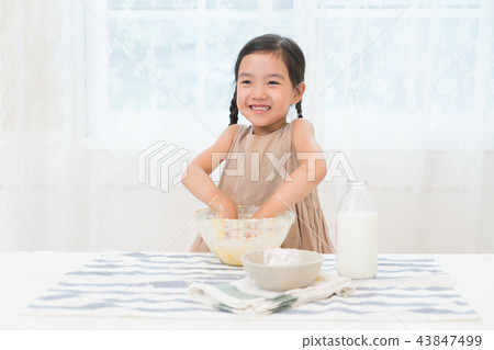 A girl enjoying home baking A girl enjoying home baking 43847499