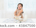 A girl enjoying home baking 43847500