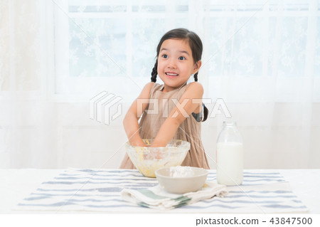 A girl enjoying home baking A girl enjoying home baking 43847500