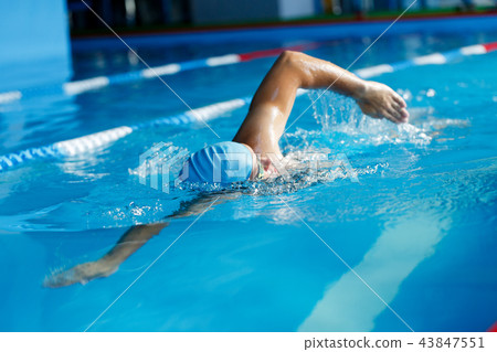 Image of athlete man in blue cap swimming in pool 43847551