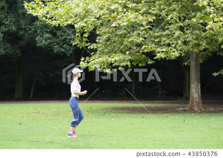 Women exercising in the park Women exercising in the park 43850376