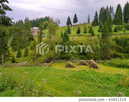 a wooden rustic house in the mountains between the 43851119