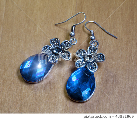 Beautiful earrings with large blue stones on a woo 43851969