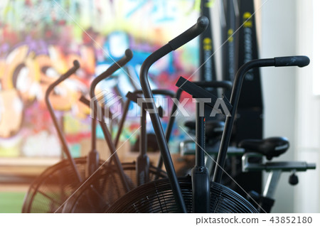 Close-up - air bikes for intensive cardio workout in the gym. 43852180