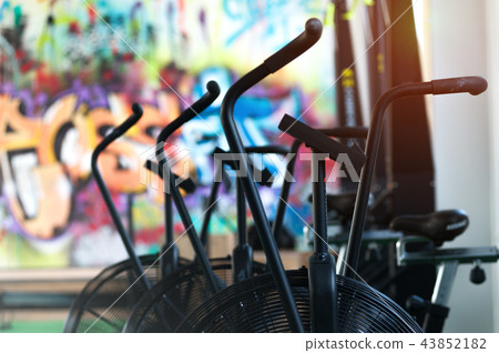 Close-up - air bikes for intensive cardio workout in the gym. Close-up - air bikes for intensive cardio workout in the gym. 43852182