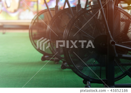 Close-up - air bikes for intensive cardio workout in the gym. Close-up - air bikes for intensive cardio workout in the gym. 43852186