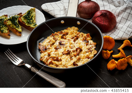 scrambled eggs with chanterelles straight from the forest in a pan and bread with avocado scrambled eggs with chanterelles straight from the forest in a pan and bread with avocado 43855415