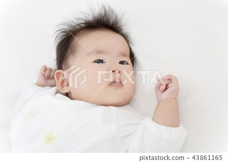 A newborn 3 months old looking at the camera wearing a white overall. Image of newborn baby, baby, parenting, health 43861165
