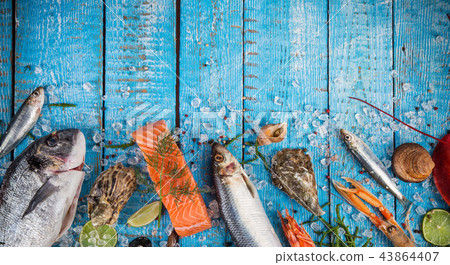 Fresh tasty seafood served on old wooden table. Fresh tasty seafood served on old wooden table. 43864407