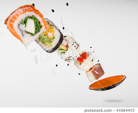 Pieces of delicious japanese sushi frozen in the air. Pieces of delicious japanese sushi frozen in the air. 43864455