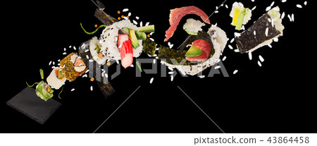 Pieces of delicious japanese sushi frozen in the air. 43864458