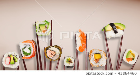 Traditional japanese sushi pieces placed between chopsticks on pastel color background. Traditional japanese sushi pieces placed between chopsticks on pastel color background. 43864460