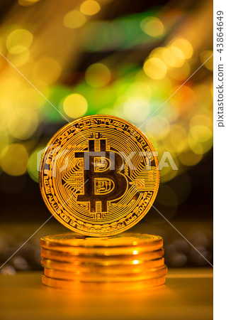 Bitcoin gold coin with defocused abstract background. Virtual cryptocurrency concept. Bitcoin gold coin with defocused abstract background. Virtual cryptocurrency concept. 43864649
