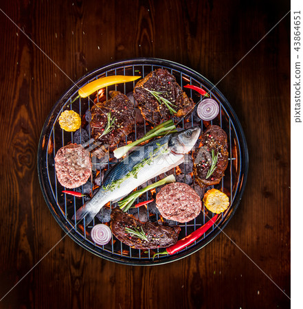 Barbecue grill with beef steaks, close-up. Barbecue grill with beef steaks, close-up. 43864651
