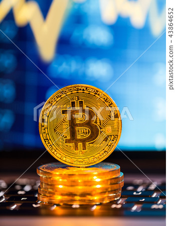 Bitcoin gold coins with laptop keyboard. Virtual cryptocurrency concept. 43864652