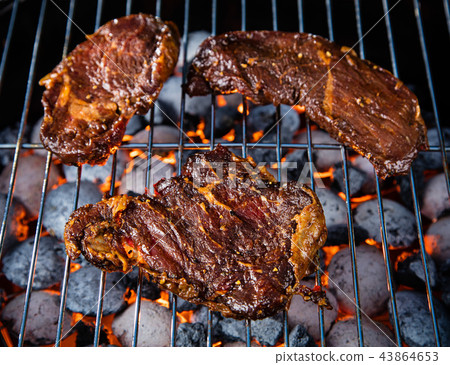 Barbecue grill with beef steaks, close-up. 43864653