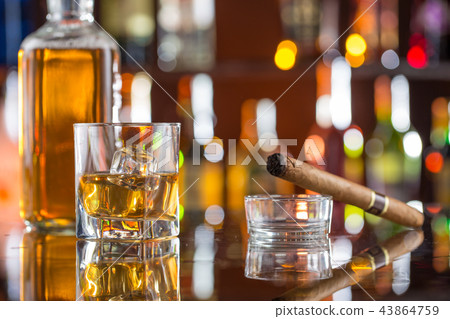 Whiskey drinks on bar counter. 43864759