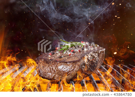 Beef steak on the grill with flames 43864780