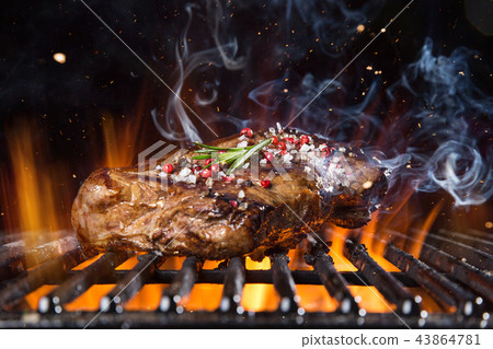 Beef steak on the grill with flames 43864781